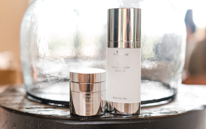 ZO Growth Factor Serum and SkinMedica TNS Advanced+ Serum in front of a glass cloche