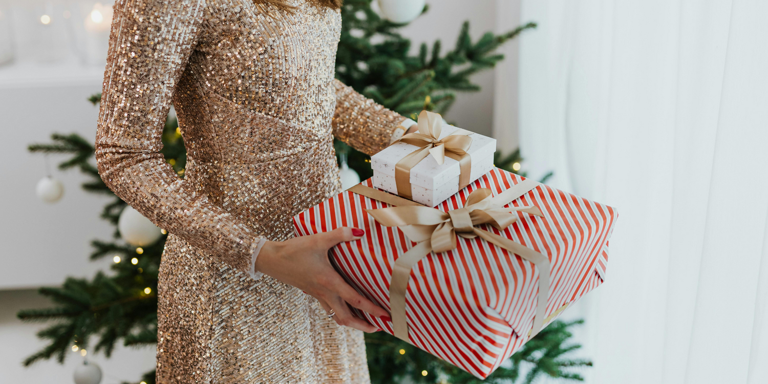 woman holding a holiday skincare gift set